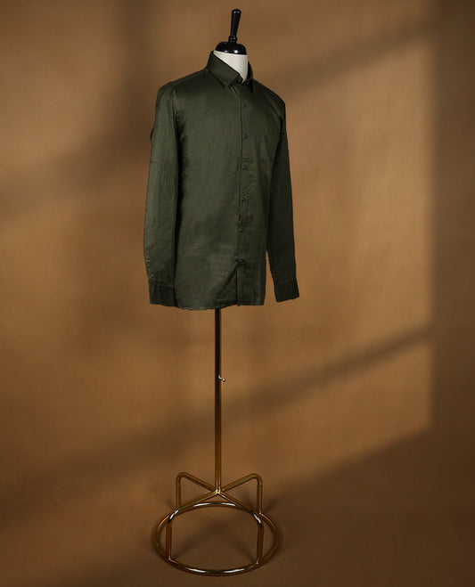 Deep olive green colour OTTO men's shirt in a relaxed formal fit, featuring a subtle self design pattern, classic collar, full sleeves, and a front chest pocket ideal for work or smart casual wear.