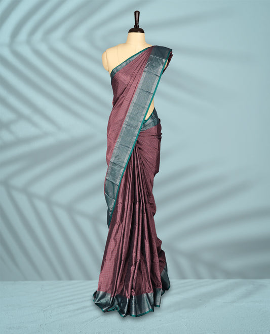 Pastel Brown colour body with delicate silver checks, paired with a contrasting green and silver zari border, comes with a matching blouse.