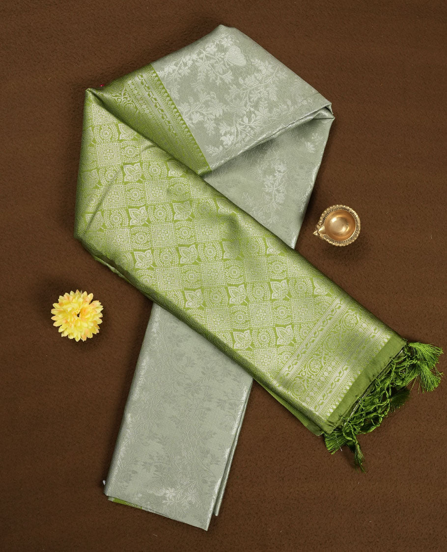 Pistachio Green colour Semi Silk Saree with Allover Subtle Floral Self-Weave on the Body, Contrasting Light Lime Zari Woven Pallu and Border Featuring Intricate Geometric Motifs and Tassels, Paired with Coordinated Blouse Piece