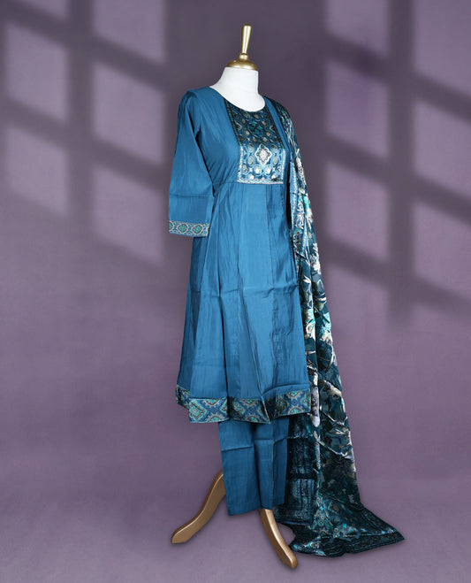 Deep Teal blue colour salwar set with round neck and elbow sleeves featuring printed yoke with ethnic motifs and contrast sleeve hem paired with matching plain bottom and digitally printed floral dupatta