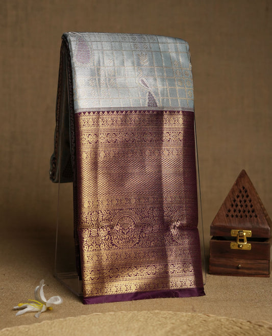 Faded blue colour and Antique gold Zari Tissue Brocade Saree features intricate check and bird Motifs on body and rich violet colour border & pallu with traditional patterns paired with contrast blouse