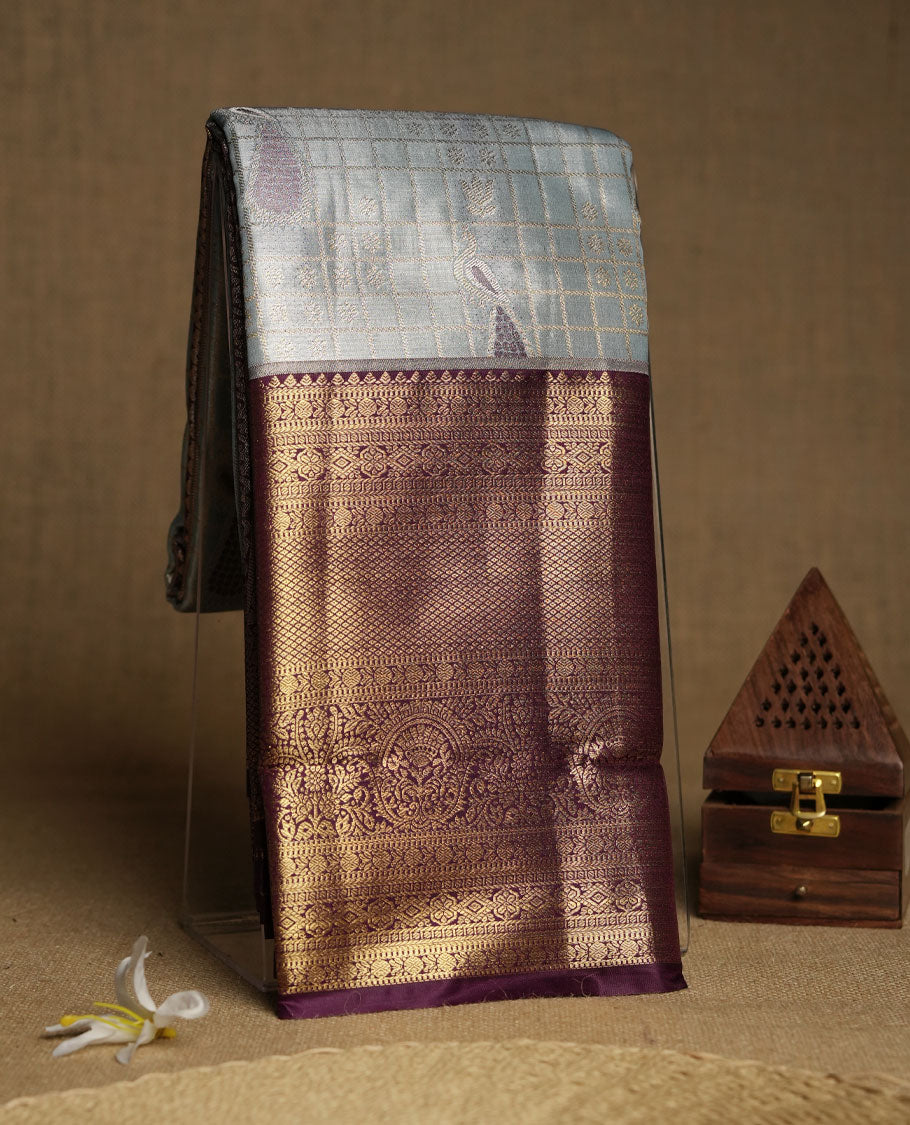 Faded blue colour and Antique gold Zari Tissue Brocade Saree features intricate check and bird Motifs on body and rich violet colour border & pallu with traditional patterns paired with contrast blouse