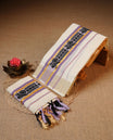 Off white colour Cotton Set Mund featuring a plain body, enhanced by a traditional black motif woven border with Lavender and gold zari stripes.