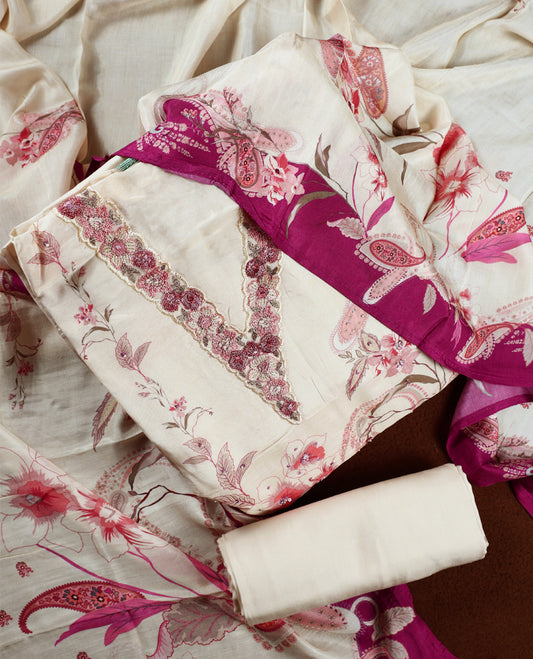 Cream colour churidhar material with pink floral and paisley prints, enhanced by a dark magenta border and delicate embroidery & Comes with matching plain bottom and dupatta.