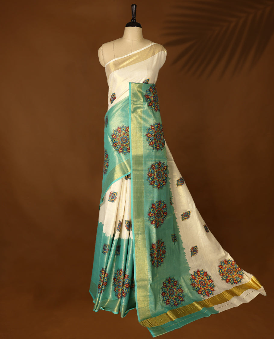 Pastel Green & Light Gold colour Tissue Kerala saree featuring Bold Floral Printed body and traditional golden zari kasavu border offering a classic and graceful look, paired with a matching blouse.
