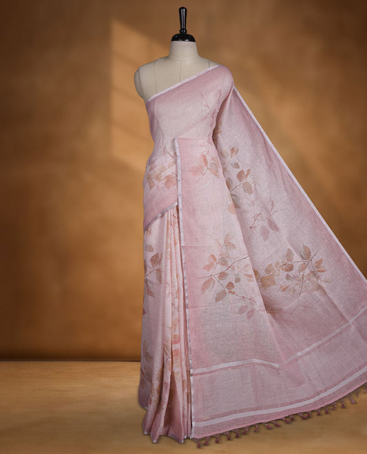Light pink colour pure linen saree featuring leaf print pattern across body, silver thin border finished with matching blouse.