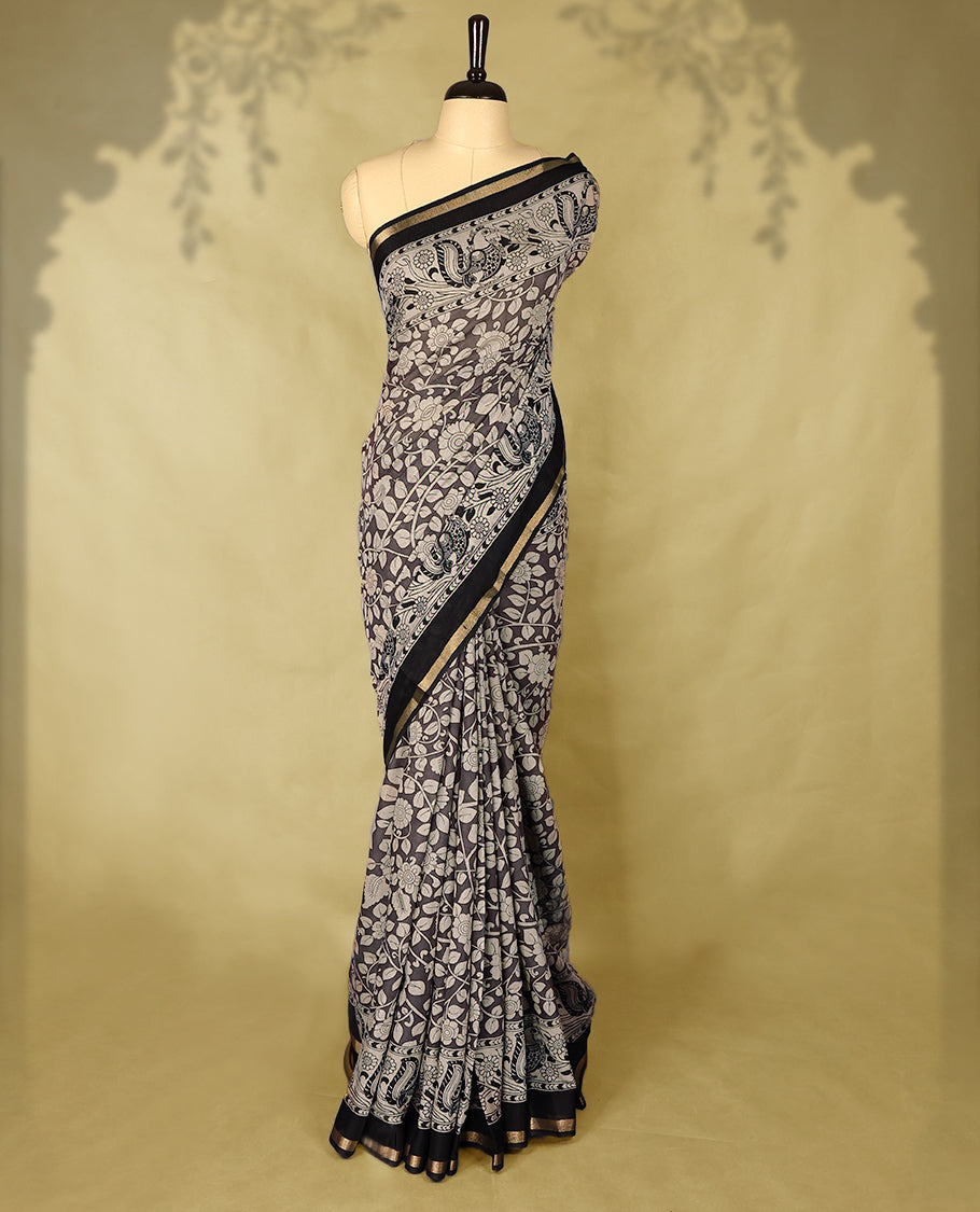 Deep Grey colour chanderi cotton saree with white floral Kodi printed body, Black border with peacock and floral motifs, grand pallu featuring large peacock designs, with matching blouse