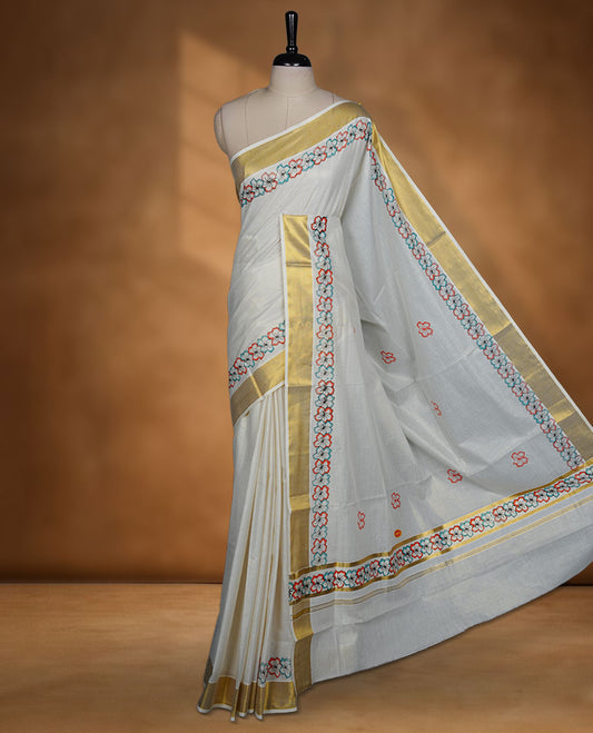 Off-white colour Kerala saree featuring floral border detailing with gold kasavu accents, complemented by a matching blouse piece.