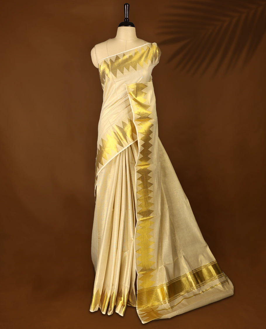 Light Gold colour Tissue Kerala saree featuring Plain body and a beautifully woven Gold Kasavu border with Diamond Patterns, paired with a matching blouse perfect for festive occasions.