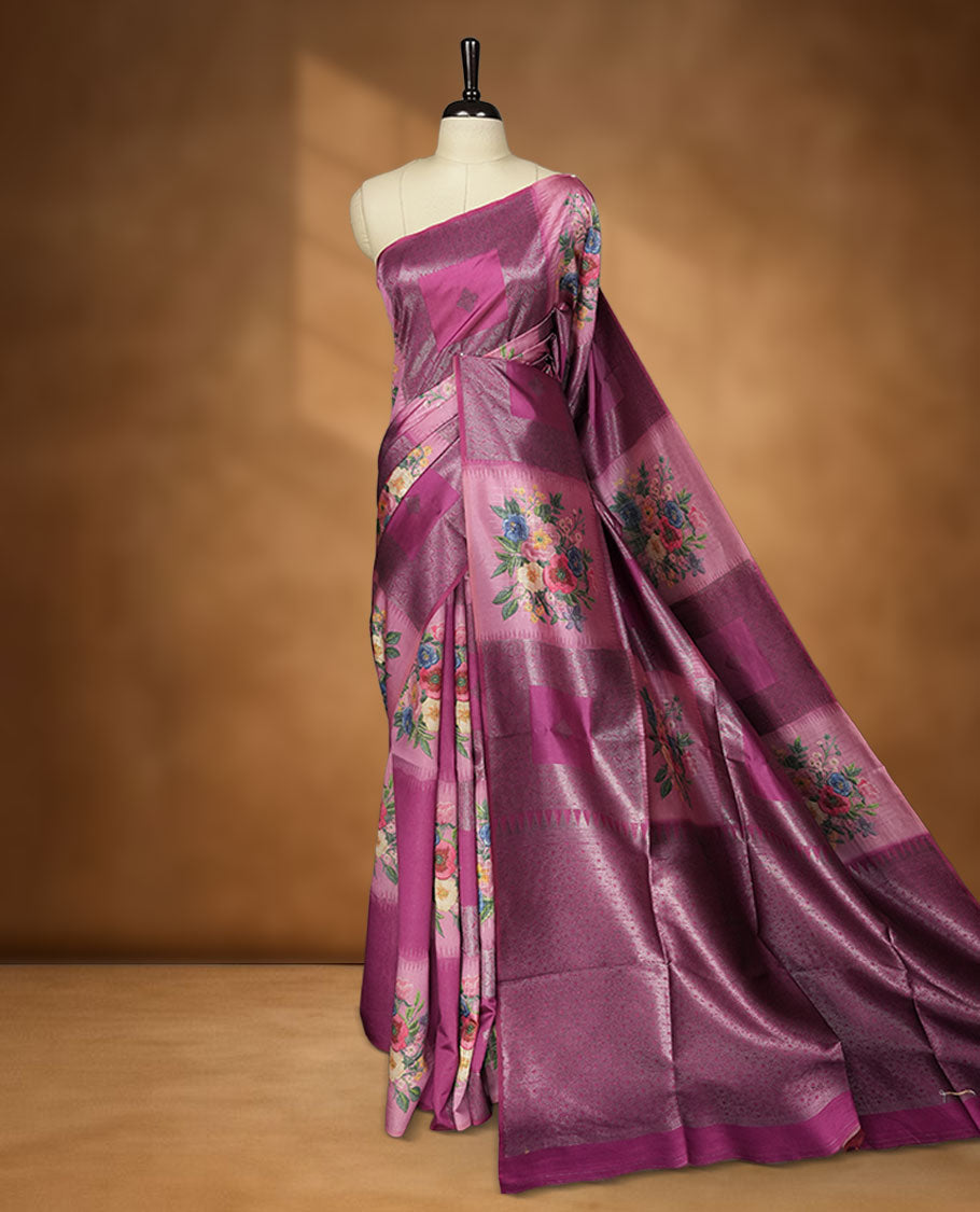 Grape colour semi tussar Banarasi saree featuring vibrant multi-color floral prints across the body, with geometric zari patterns, and a matching blouse detailed with silver woven buttas.