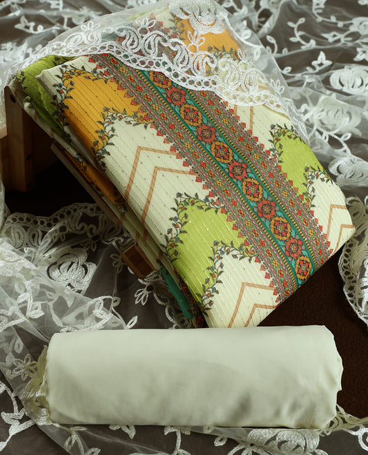 Cream colour churidhar material with embroidered neck work, floral motifs in yellow, green & orange shades, and patterned detailing on the body & Comes with matching plain bottom and embroidered net dupatta.
