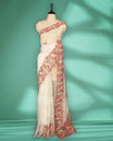 Off white colour organza saree featuring delicate floral and bird themed embroidery with scalloped edges on the border and pallu, lending a graceful charm. Paired with a matching blouse.