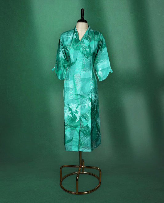 Teal green straight cut kurti with tonal abstract prints and delicate stone work on the body, featuring a V neck with notched collar and elbow length sleeves with button tabs.