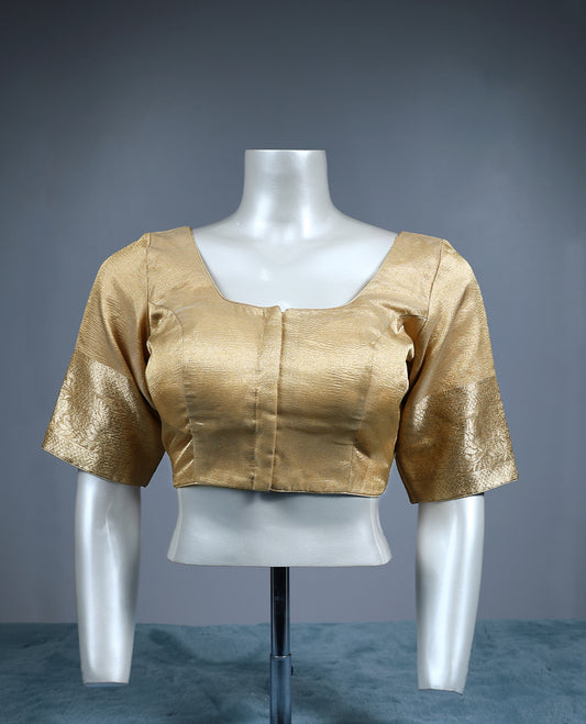 Golden tissue padded readymade blouse with a subtle sheen, highlighted by elbow length zari woven sleeves and a square neckline an elegant versatile piece ideal for silk and festive sarees.