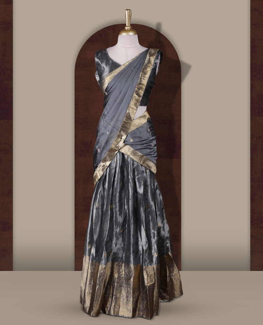 Gray colour Dhavani set featuring a Gray colour skirt with contrast Gold colour border with rich gold zari pattern, paired with a Matching dupatta detailed with Gold motifs.