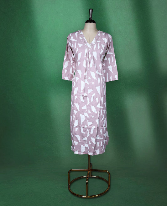 Pastel pink colour kurti featuring white tribalinspired geometric prints, styled with a V neckline adorned with subtle thread embroidery and 3/4th sleeves ideal for a contemporary ethnic look.