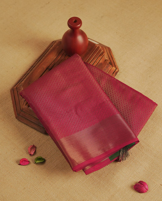 Maroon colour semi silk saree featuring neem zari Brocade Pattern all over the body, complemented by a Self Colour woven border with detailing with contrast green Colour Pallu & blouse.