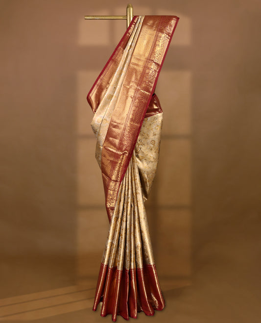 Gold colour tissue brocade saree with gold and silver zari floral design on body, gold zari peacock & Flower traditional work Maroon border, rich matching pallu with Antique zari motifs, paired with matching blouse.