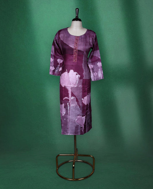 Plum purple colour kurti with a round neckline and three quarter sleeves, featuring abstract floral prints in soft lilac tones and a delicately Printed front placket for a graceful contemporary style.