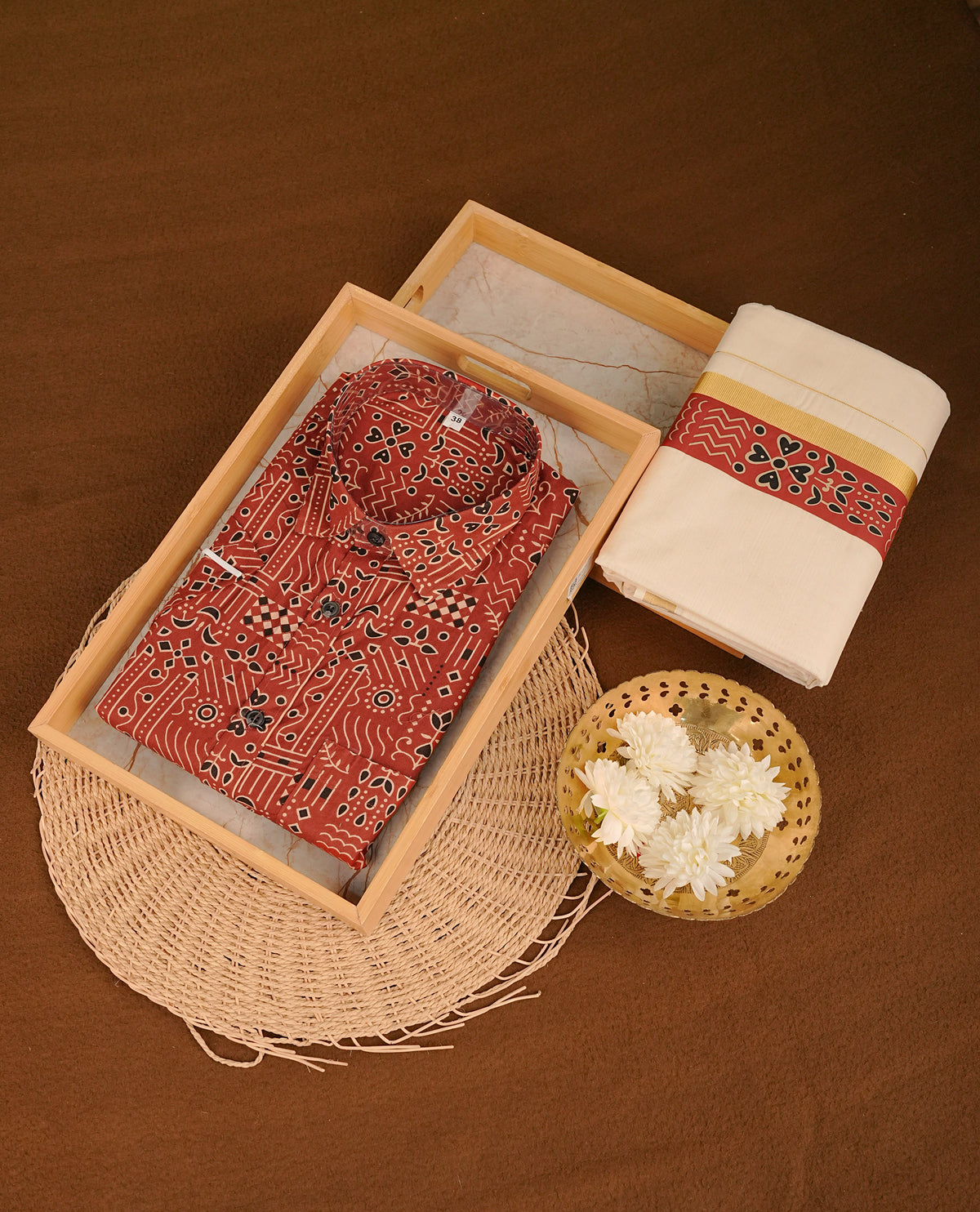 Maroon colour shirt featuring Floral Pattern printed body, paired with cream colour double dhoti featuring Gold kara with printed border.