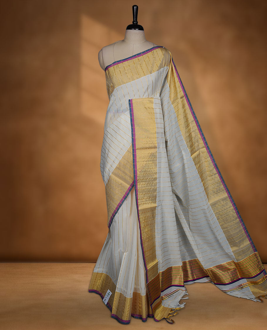 Off-white colour kerala saree with fine gold stripes, rich zari border and pallu highlighted by elegant pink and blue edging, paired with a matching blouse.