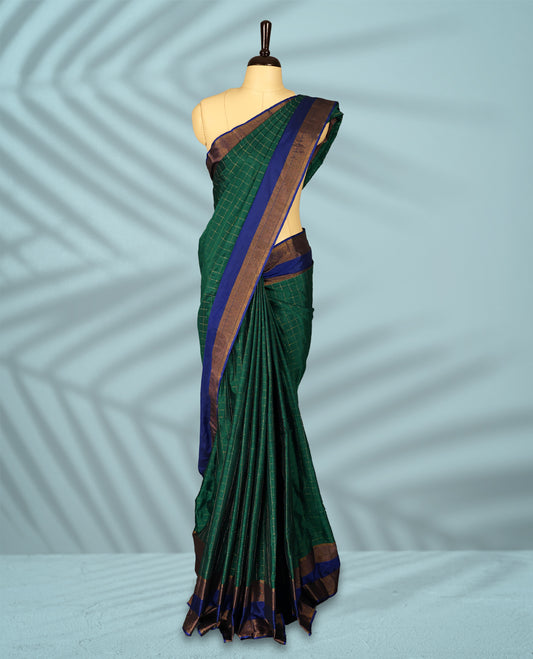 Green Colour semi silk saree features golden thread checks all over, complemented by a rich contrast blue and Golden zari border, and comes with a matching blouse.