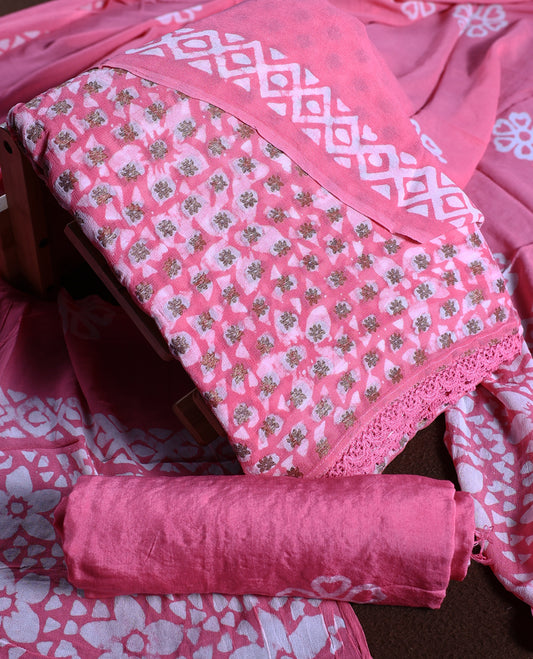 Pink colour churidhar material adorned with gold and copper toned floral patterns and bold block designs, paired with a plain matching bottom & Comes with a floral flowery printed dupatta.