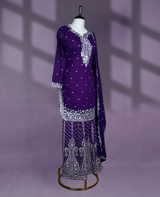 Royal purple colour sharara set features intricate silver embroidery on the neckline, sleeves, and hem, with heavily embroidered sharara bottom and matching dupatta complete this elegant ensemble.