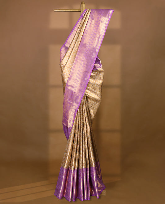Gold colour tissue brocade saree with gold and silver zari pattern on body, gold zari traditional floral kodi work lavender border, rich matching pallu with Antique zari motifs, paired with matching blouse.
