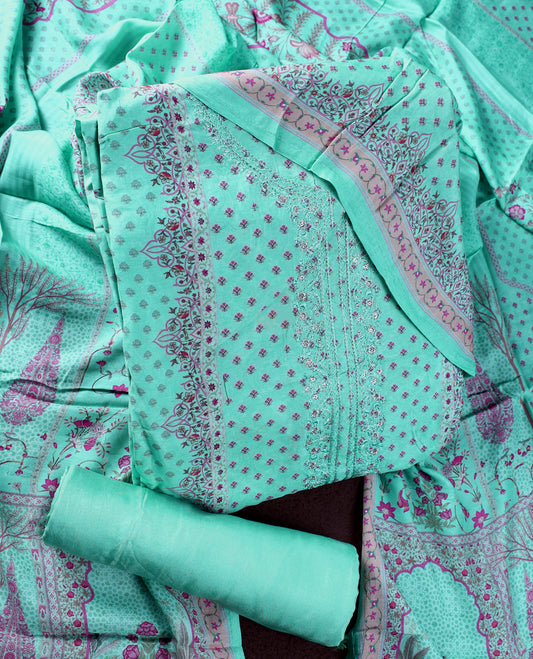 Sea green colour churidhar material featuring delicate peach prints and fine embroidery on the neckline, paired with a matching printed dupatta and plain bottom.