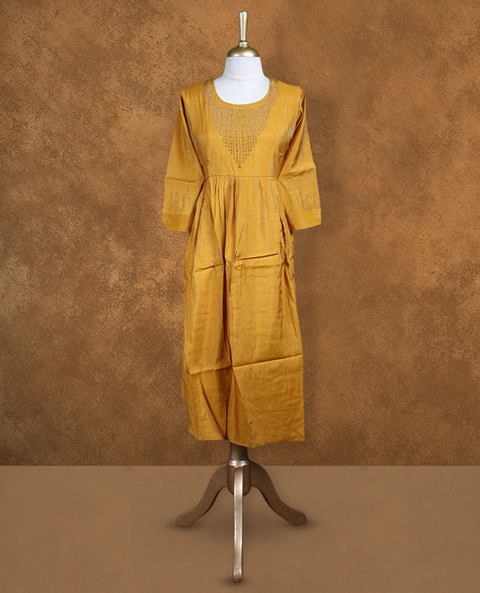 Mustard colour kurti highlighted with intricate cutwork detailing along the scoop neckline, styled with gathered waist and comfy 3/4th sleeves.