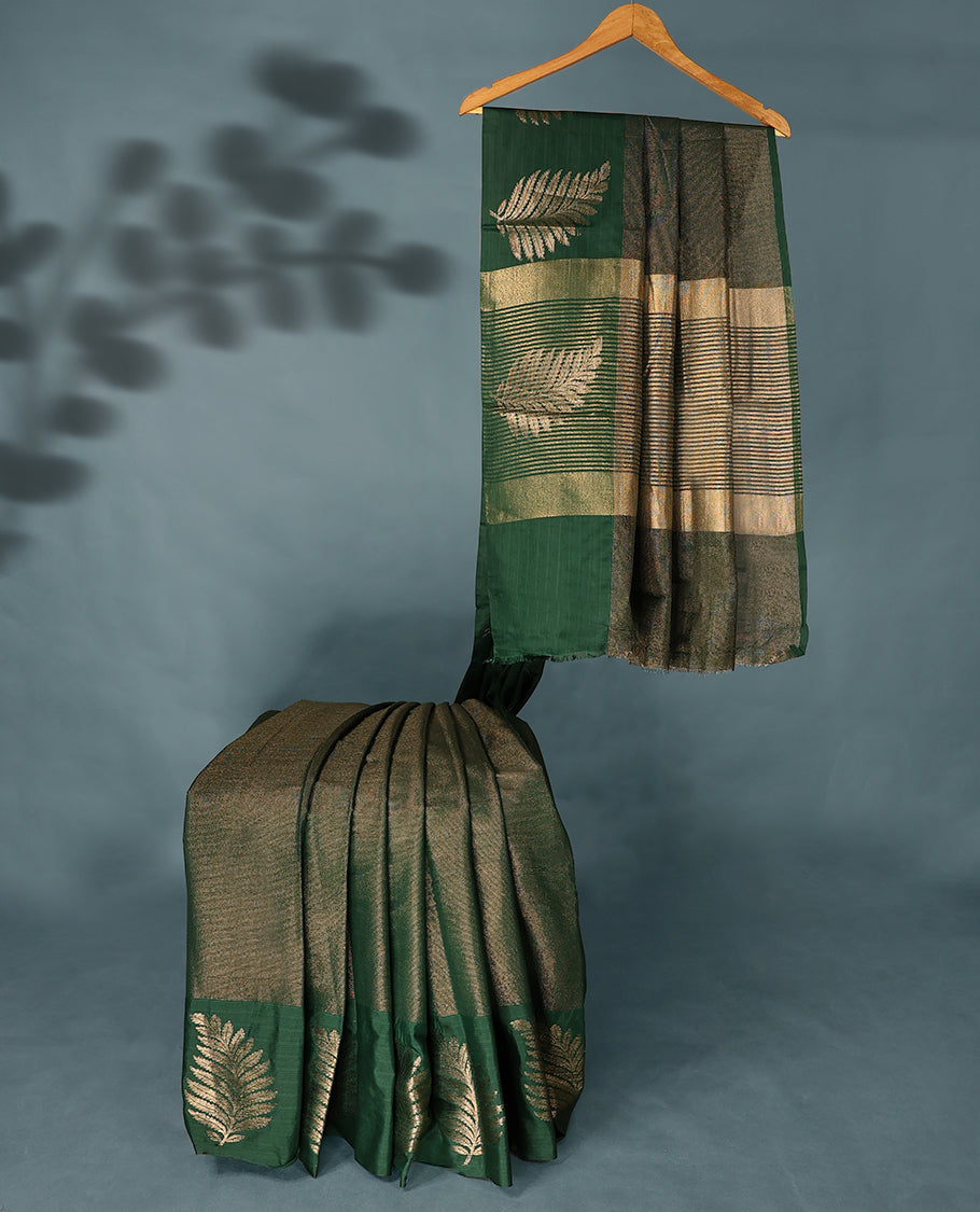 Bottle Green Colour Semi Tussar Silk saree featuring golden zari horizontal lines across the body, adorned with bold Leaf motifs on the border, paired with a matching blouse.