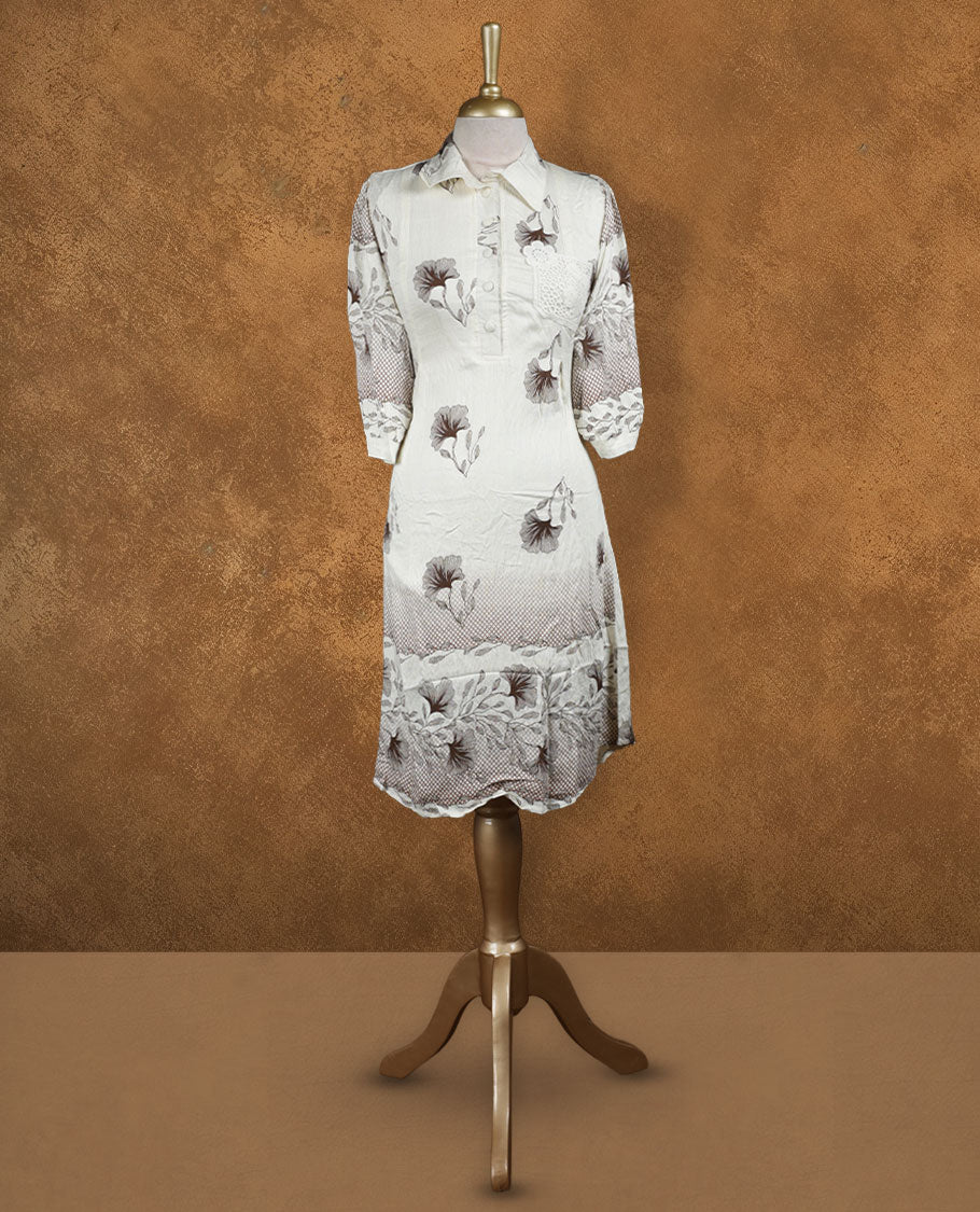 Ivory floral printed shirt dress with collared neckline, half button placket, lace-appliqué detail on chest, three-quarter sleeves, and scalloped hemline.