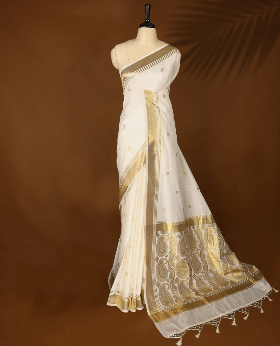 Elegant white colour sotf  Tussar Kerala saree featuring Flower motifs on body, Gold kasavu border, Rich Pallu, Paired with matching blouse offering a classic and graceful look