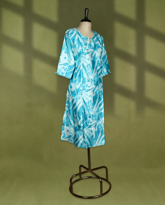 Bright turquoise blue straight cut kurti featuring bold Off white abstract prints, styled with a round neckline and keyhole detail, 3/4th sleeves and side slits, ideal for everyday summer wear.