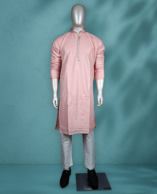 Peach colour georgette kurta set featuring self colour thread and sequin work on the body, full sleeves, and paired with a matching bottom.