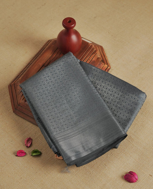 Slate gray colour semi silk saree featuring neem zari Brocade Pattern all over the body, complemented by a Self Colour woven border with detailing, Pallu & blouse.