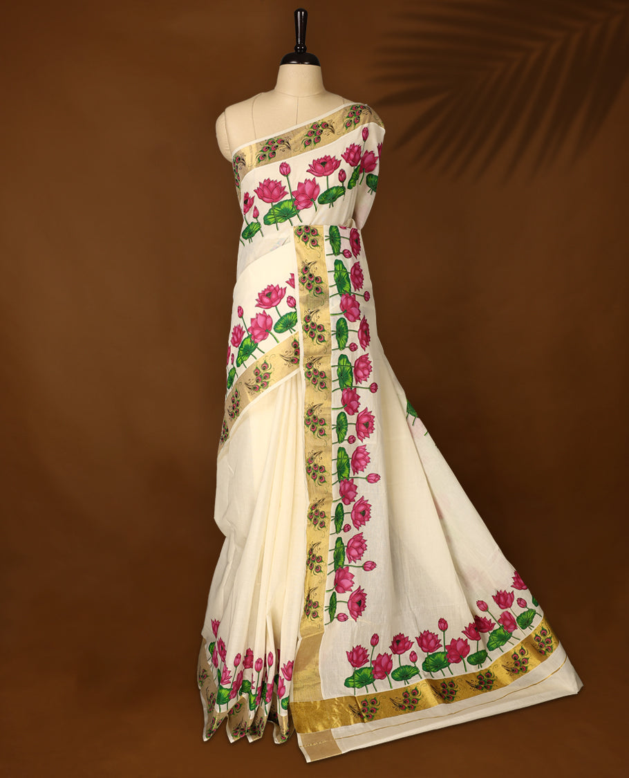 Elegant off white Kerala cotton saree with vibrant pink lotus digital prints and a rich golden zari border. Perfect blend of tradition and charm, paired with a matching blouse piece for a complete look.