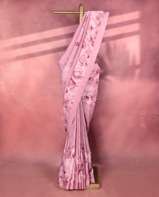Dusty rose pink pure linen saree featuring floral digital prints across the body, the saree complemented by a simple solid border that adds understated charm, it pairs with a matching blouse