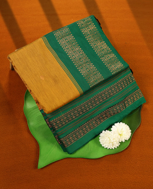 Green and Mustard colour Kalyani cotton saree featuring zari woven patterns across the body, paired with a rich Green colour traditional zari border and pallu, with matching blouse
