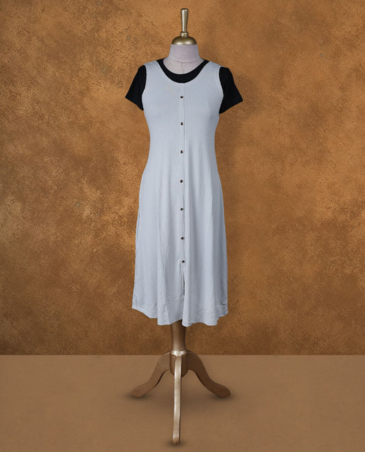 Light grey sleeveless A-line midi dress with front button detailing, layered over a black crew-neck short-sleeve inner tee.