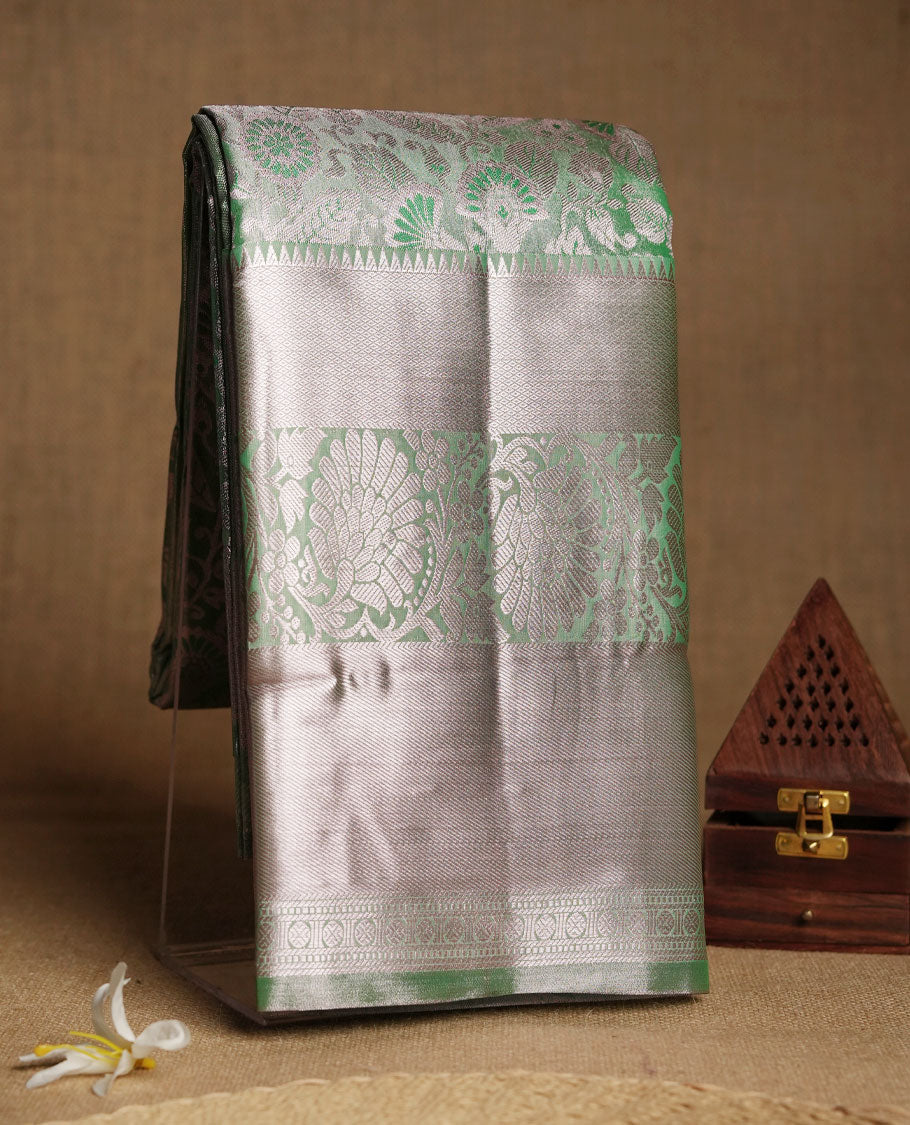 Pastel green colour and Antique gold Zari Tissue Brocade Saree features intricate floral Motifs on body and light rose gold border & pallu with floral patterns, paired with matching blouse