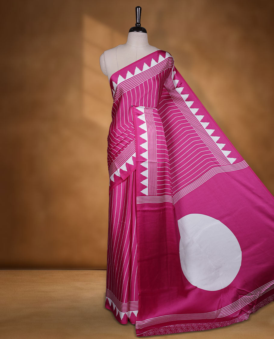 Dark Pink colour semi modal saree featuring bold white geometric borders and fine stripe detailing, finished with an oversized white circular motif on the pallu, paired with a matching printed blouse.