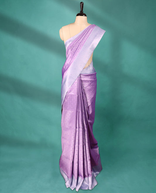 Violet coloured semi silk saree featuring a Silver coloured Zari design on the body, paired with a Baby Blue coloured border and matching blouse.