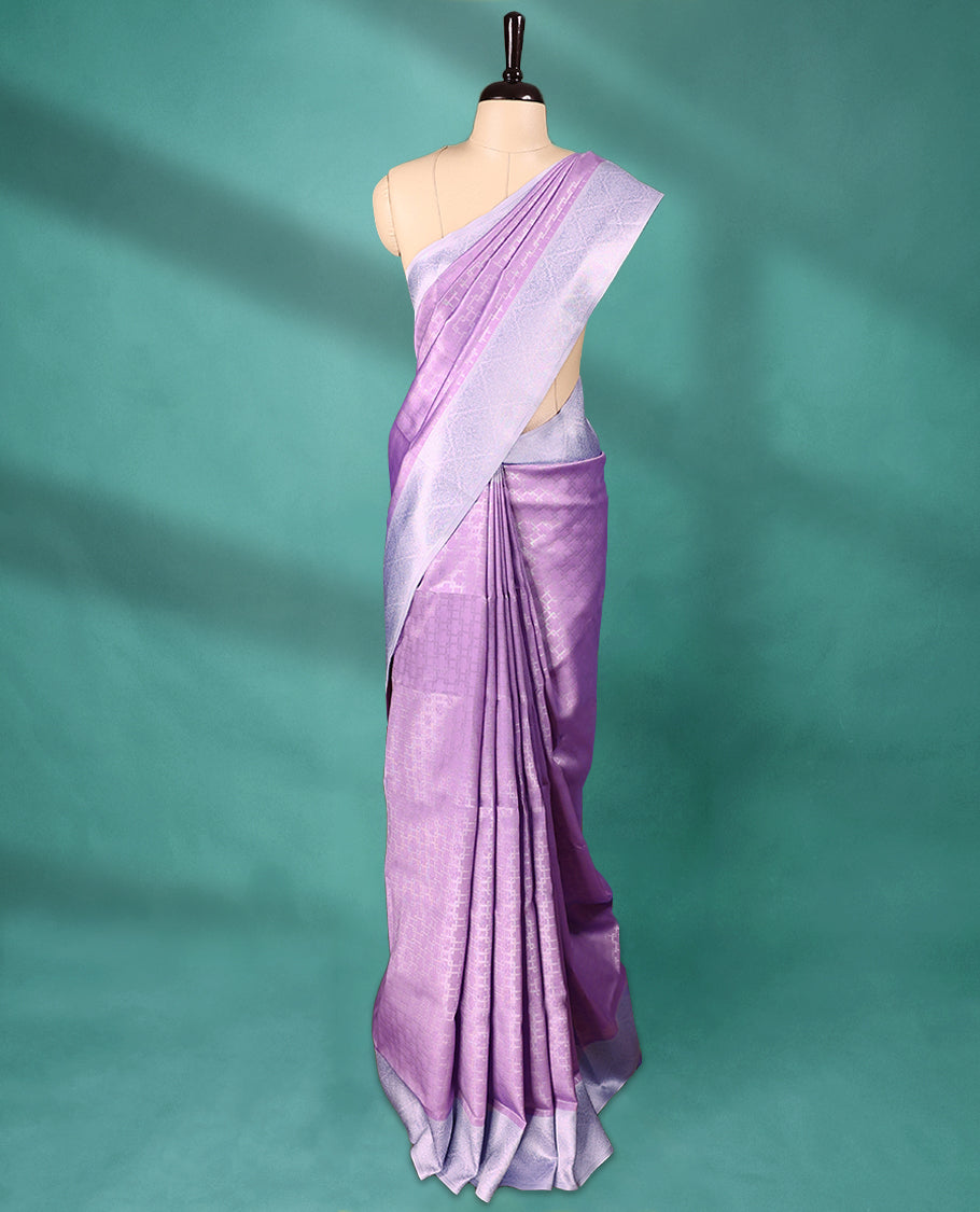 Violet coloured semi silk saree featuring a Silver coloured Zari design on the body, paired with a Baby Blue coloured border and matching blouse.
