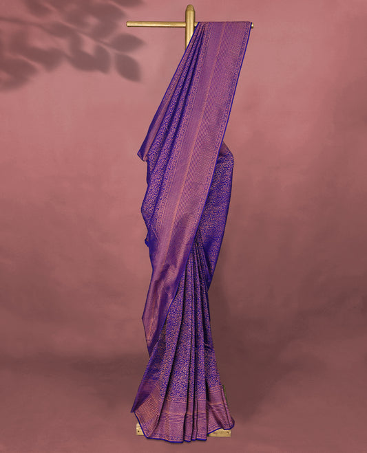 Deep Violet colour Kancheepuram saree featuring an antique zari brocade body, complemented by a traditional border and a matching blouse.