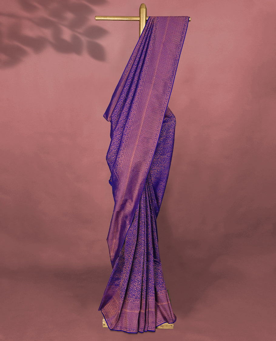 Deep Violet colour Kancheepuram saree featuring an antique zari brocade body, complemented by a traditional border and a matching blouse.