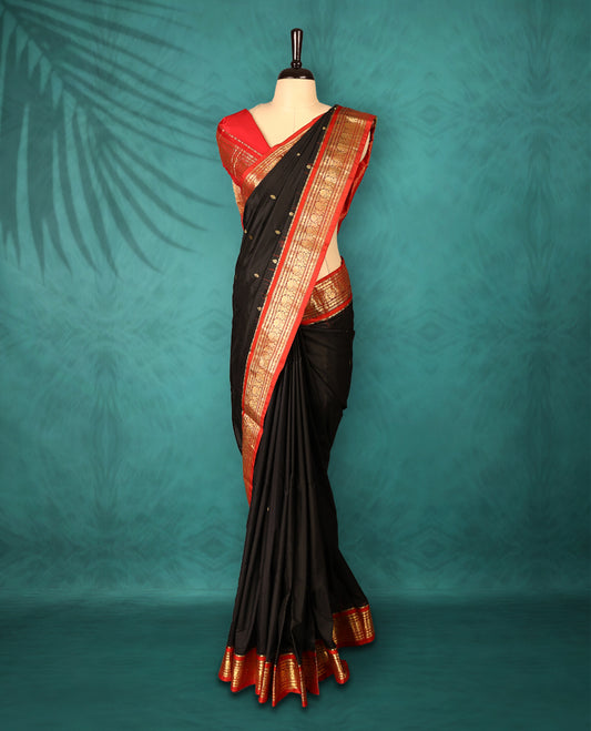 Black colour Traditional Kancheepuram Silk saree with small gold motifs on body, Rich red traditional border with intricate gold zari weaving, grand zari pallu, perfect for Bharatanatyam, with matching blouse.