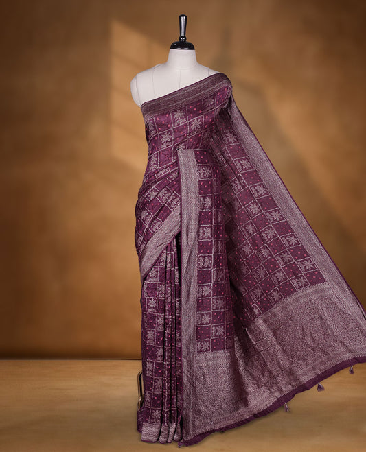 Deep dark purple colour Banarasi Bandhani silk saree featuring with intricate Banarasi motifs on body, complemented by antique zari woven border and grand pallu, paired with matching  blouse