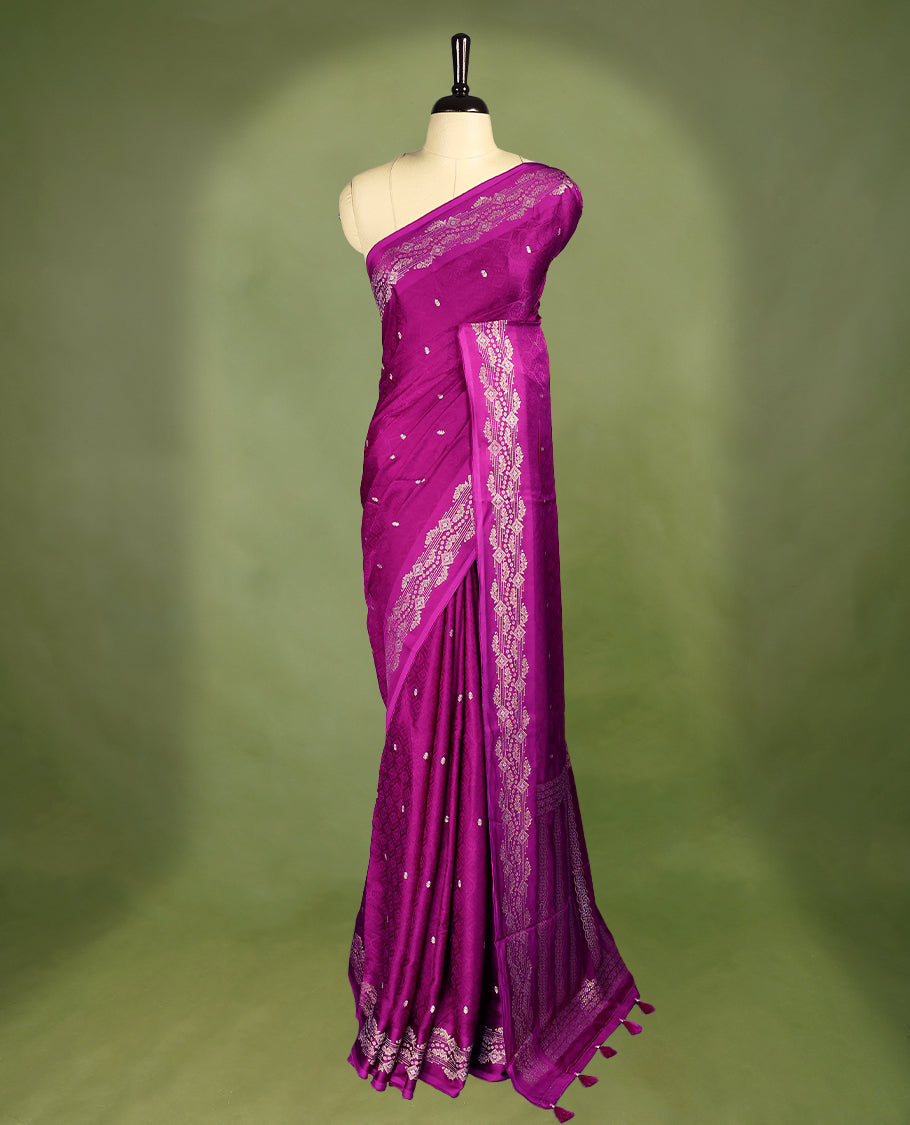 Grape colour pure Banaras crepe saree showcases elegant Gold & Silver zari Motifs all over the body, a traditional gold & Silver zari border, a rich intricately woven pallu, and comes with a matching blouse.